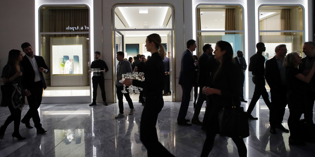FILE- In this March 14, 2019, file photo people attend the opening of a Piaget store during the opening night of The Shops & Restaurants at Hudson Yards in New York. On Monday, April 1, the Commerce Department releases U.S. retail sales data for February. (AP Photo/Mark Lennihan, File)