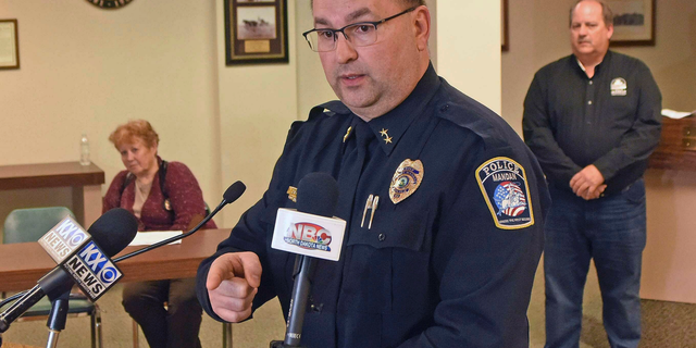 Mandan Police Chief Jason Ziegler announces an arrest in a quadruple homicide at a press conference Thursday night, April 4, 2019, in Mandan, N.D. In back are Deputy Police Chief Lori Flaten, left, and Mandan Mayor Tim Helbling. Police in North Dakota say they've arrested a 44-year-old man in the slayings of four people earlier this week at a business in Mandan. Ziegler says surveillance video identified a vehicle of interest and helped lead them to the suspect, who lived in the small town of Washburn about 35 miles (56 kilometers) north of Mandan. (Tom Stromme/The Bismarck Tribune via AP)