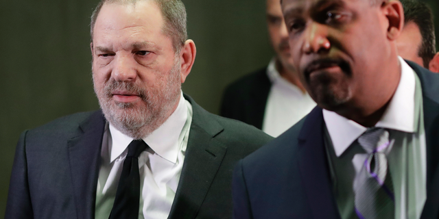 Harvey Weinstein, left, leaves court with attorney Ron Sullivan in New York.