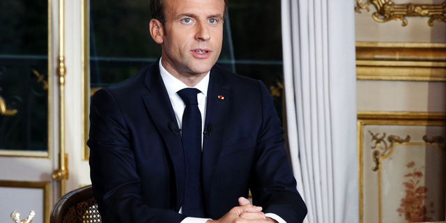 French President Emmanuel Macron sits at his desk after addressing the French nation following a massive fire at Notre Dame Cathedral, at Elysee Palace in Paris, on April 16, 2019.