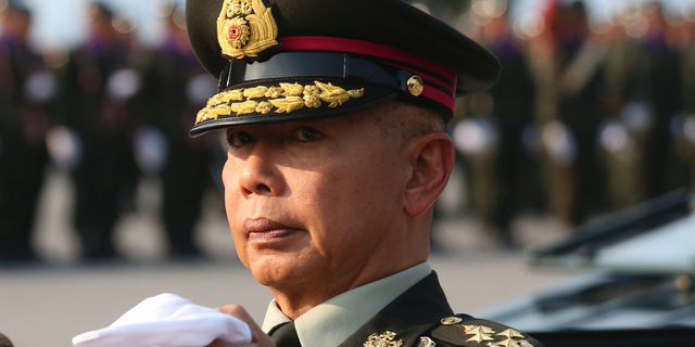 In this Friday, Jan. 18, 2019, file photo, Thai army chief Gen. Apirat Kongsompong reviews the guard of honor during the Royal Thai Armed Forces Day ceremony at a military base in Bangkok, Thailand. Apirat has warned that the military will strongly fight any moves that threaten the country's system of a constitutional monarchy with the king as head of state. (AP Photo/Sakchai Lalit)