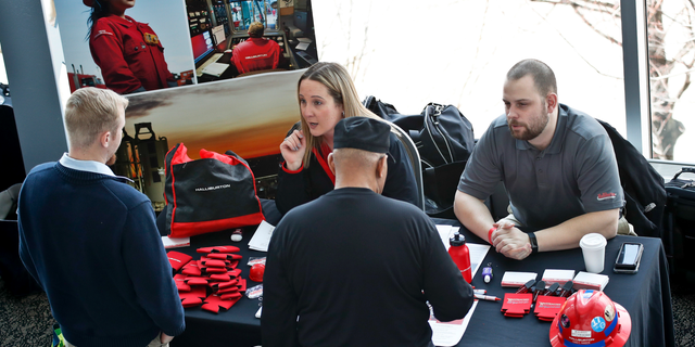 FILE- In this March 7, 2019, file photo visitors to the Pittsburgh veterans job fair meet with recruiters at Heinz Field in Pittsburgh. On Friday, April 5, the U.S. government issues the March jobs report. (AP Photo/Keith Srakocic, File)