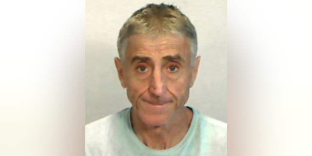 In this April 6, 2019, photo made available by the Monroe County Sheriff's Office, Fla., shows Francis Lippi under arrest. Key West police said Lippi was arrested on a felony charge of grand theft. Lippi recently bought an $8 million island off Key West. He is accused in a scheme to steal $300 in household items from Kmart. (Monroe County Sheriff's Office via AP)