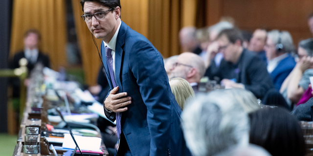 Canadian Prime Minister Justin Trudeau rises to vote during a marathon voting session as it continues into the night in the House of Commons on Parliament Hill in Ottawa, Ontario, on Wednesday, March 20, 2019. (Justin Tang/The Canadian Press via AP)