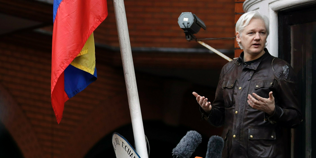 FILE - In this Friday May 19, 2017 file photo, WikiLeaks founder Julian Assange gestures as he speaks on the balcony of the Ecuadorian embassy, in London. A senior Ecuadorian official said no decision has been made to expel Julian Assange from the country's London embassy despite tweets from Wikileaks that sources had told it he could be kicked out within "hours to days." A small group of protesters and supporters gathered Thursday April 4, 2019 outside the embassy in London where Assange has resided for 12 years. (AP Photo/Matt Dunham, File)