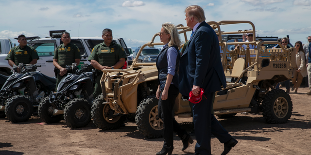 President Donald Trump walks with Homeland Security Secretary Kirstjen Nielsen as they visit a newly constructed part of a border wall with Mexico in Calexico, Calif., Friday April 5, 2019. (AP Photo/Jacquelyn Martin)