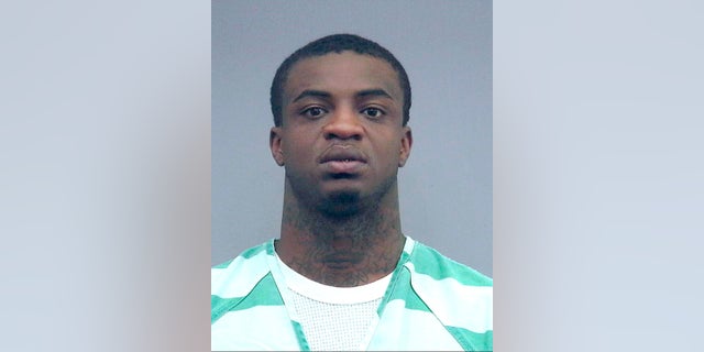 In this April 10, 2019 photo made available by the Alachua County Sheriff's Office shows Christopher McCallum under arrest. McCallum, a Florida rapper, was arrested after threatening a mass shooting after song lyrics posted on Facebook say he will "catch you at a Gator game and shoot the whole campus up." (Alachua County Sherriff's Office via AP)