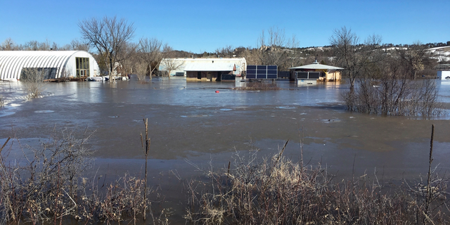 In this undated March 2019 photo provided by Henry Red Cloud, shows flooding on Cloud's Lakota Solar Enterprises property on the Pine Ridge Reservation in southern South Dakota. Red Cloud estimates flood damage at $250,000. Plains and Midwest states are bracing for another massive winter storm Wednesday and Thursday and the prospect of renewed flooding when the snow melts. (Henry Red Cloud via AP)