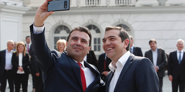 North Macedonia Prime Minister Zoran Zaev, left, takes a selfie with his Greek counterpart Alexis Tsipras, outside the Prime Minister office in Skopje, North Macedonia, on Tuesday, April 2, 2019. Greek Prime minister has arrived in North Macedonia, the first ever official visit of a Greek leader to neighboring country after decades of strained relations between two nations burdened over the name "Macedonia".(AP Photo/Boris Grdanoski)