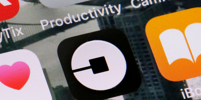 The Uber application icon is visible on a phone in New York on June 12, 2018. (Associated Press)