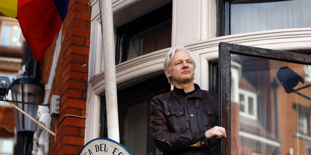 FILE- In this Friday May 19, 2017 file photo, WikiLeaks founder Julian Assange greets supporters outside the Ecuadorian embassy in London. Ecuador's President Lenin Moreno said on Tuesday, March 2, 2019, that he wants to reach an agreement for Assange to leave the Embassy in London as soon as possible, as long as his life is not in danger. (AP Photo/Frank Augstein, File)