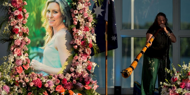 FILE - In this Aug. 11, 2017, file photo, Johanna Morrow plays the didgeridoo during a memorial service for Justine Ruszczyk Damond at Lake Harriet in Minneapolis. Jury selection is scheduled to begin, Monday, April 1, 2019, in the trial of a former Minneapolis police officer who fatally shot the unarmed Australian woman after she called 911 to report a possible sexual assault behind her home. Mohamed Noor is charged with murder in the July 2017 death of Damond - a case that drew international attention and led to changes at the city's police department. He has pleaded not guilty. (Aaron Lavinsky/Star Tribune via AP, File)
