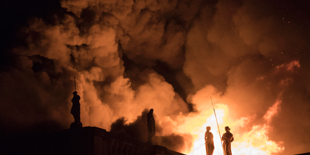 FILE - In this Sept. 2, 2018 file photo, flames engulf the 200-year-old National Museum of Brazil, in Rio de Janeiro. Federal police say an air conditioning unit is the “primary cause” of the fire that destroyed Brazil’s National Museum in Rio de Janeiro. Fire experts have presented the conclusions of a seven-month investigation into the Sept. 2, 2018 fire, which began in the museum’s auditorium and quickly spread to the rest of the building, destroying most of its 20 million artifacts. (AP Photo/Leo Correa, File)