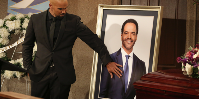 Shemar Moore, portraying Malcolm Winters, pays respects during a funeral scene for St. John's character Neil Winters.