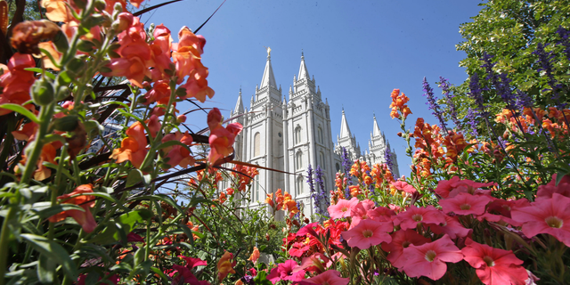 FILE - This Aug. 4, 2015 file photo, flowers bloom in front of the Salt Lake Temple, at Temple Square, in Salt Lake City. The Church of Jesus Christ of Latter-day Saints is repealing rules unveiled in 2015 that banned baptisms for children of gay parents and made gay marriage a sin worthy of expulsion. The surprise announcement Thursday, April 4, 2019, by the faith widely known as the Mormon church reverses rules that triggered widespread condemnations from LGBTQ members and their allies. (AP Photo/Rick Bowmer, File)