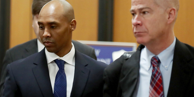 Former Minneapolis police officer Mohamed Noor, center, is accompanied by his attorneys Peter Wold, not pictured, and Thomas Plunkett, right, as he walks towards the Hennepin County Government Center for opening arguments of his trial Tuesday, April 9, 2019, in Minneapolis Opening arguments scheduled to begin in the trial of former Minneapolis police officer Mohamed Noor in the shooting death of Justine Ruszczyk Damond. (David Joles/Star Tribune via AP)