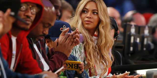 In this Feb. 19, 2017. file photo, Beyonce sits at court side during the second half of the NBA All-Star basketball game in New Orleans. Netflix on Sunday, April 7, 2019 posted on its social media channels a yellow image with the word “Homecoming” across it. The only other information was a date: April 17. That’s when Netflix is expected to premiere a Beyonce special that may feature her performances at last year’s Coachella Valley Music and Arts Festival.
