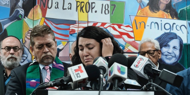 Melissa Castro tries to force back tears as she talks about her husband, Jose Luis Ibarra Bucio, while joined by local religious leaders during a news conference at the offices of the Coalition for Humane Immigrant Rights of Los Angeles (CHIRLA), Wednesday, April 10, 2019, in Los Angeles. The family of the 27-year-old man who died after a short stint in a California immigration detention facility demanded answers Wednesday about what happened to him and the timing of his release. Melissa Castro said her husband, was released as his health deteriorated from a brain hemorrhage and while he was in a coma from which he never awoke. (AP Photo/Richard Vog)el