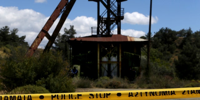 Cypriot investigators and police search a flooded mineshaft where two female bodies were found, outside Mister village near the capital Nicosia, Cyprus, Monday, April 22, 2019.