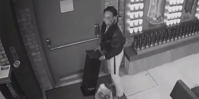 Image taken from surveillance video released by the NYPD showing a woman wanted for pilfering a donation box during a break-in at a parish church in New York last week.