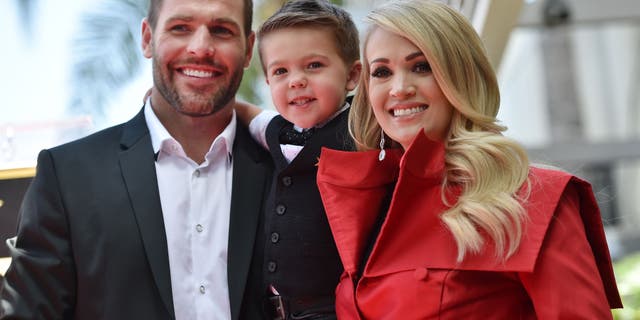 Carrie Underwood is pictured here with husband Mike Fisher and their son Isaiah at Underwood's star unveiling ceremony on the Hollywood Walk of Fame on September 20, 2018.