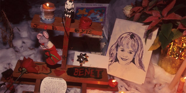 People light candles at the murder site of 6-year-old JonBenet Ramsey in Boulder, Colorado. — Photo by Karl Gehring/Liaison