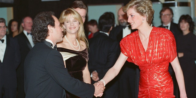 The Princess of Wales, Princess Diana, attends the Premiere of "When Harry Met Sally..." in London's West End. The Princess, wearing a Bruce Oldfield red chiffon dress embroidered in a tartan design in silver Lam, talks to American actors Meg Ryan and actor Billy Crystal who star in the film, 30th November 1989. — Photo by Kent Gavin/Daily Mirror/Mirrorpix/Getty Images