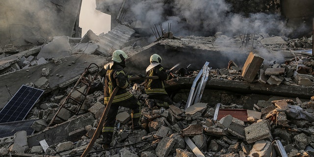 22 March 2019, Syria, Idlib: Members of the Syrian civil defense extinguish a fire in a house allegedly targeted by an airstrike in the town of Kafraya in the north of Idlib. According to activists 10 people died in airstrikes allegedly carried out by Russian warplanes.