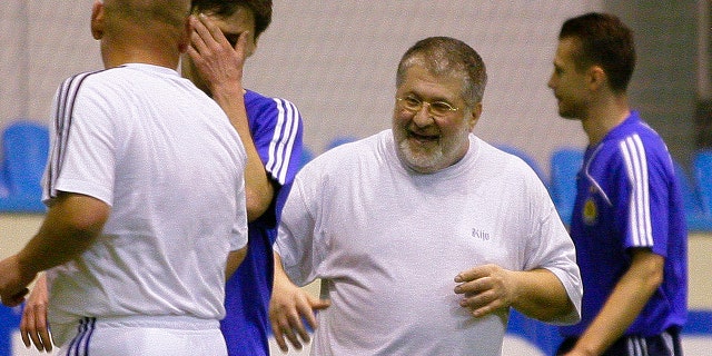 In this photo taken in Feb. 26, 2010, Ukrainian a self-exiled billionaire businessman Ihor Kolomoyskyi, center, plays soccer in Kiev, Ukraine. (AP Photo/Andriy Lukatsky, File)