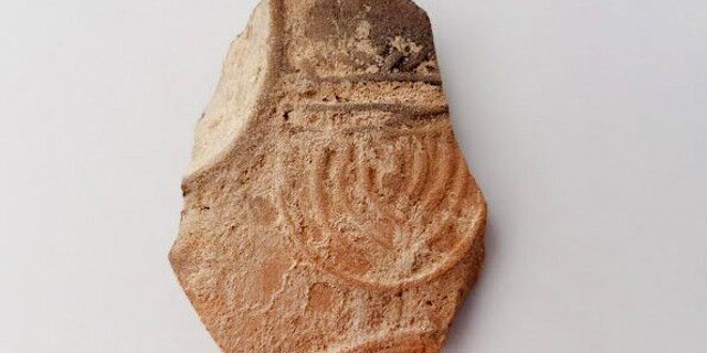 Oil lamp sherd decorated with a nine-branched menorah