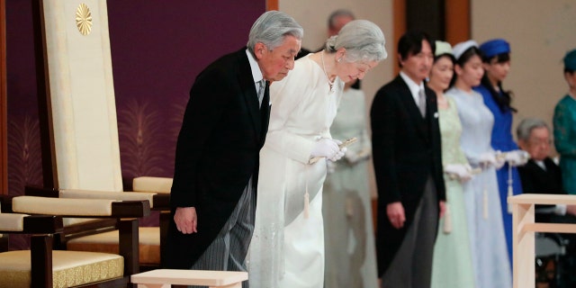 Japan's Emperor Akihito, left, and Empress Michiko, second left, bow as they prepare to leave after the ceremony of his abdication at the Imperial Palace in Tokyo, Tuesday. (Japan Pool via AP)
