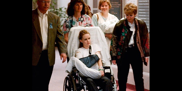 Kacey Ruegsegger, 17, is wheeled from a Denver hospital by Patty Anderson, center, after being released in May 1999.
