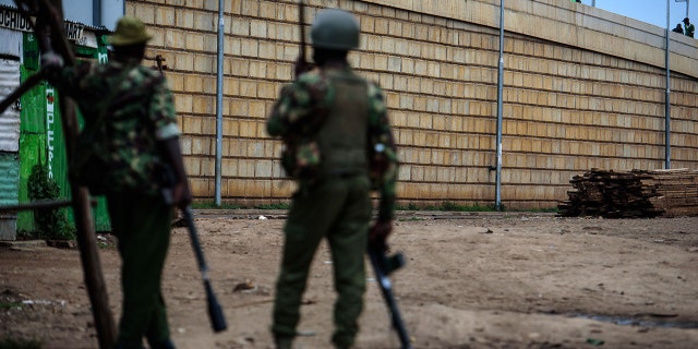 Protesters face anti-riot police on October 25, 2017 in the Kondele district of Kisumu, an opposition stronghold in western Kenya, a day before the scheduled repeat presidential poll. (Photo credit should read JENNIFER HUXTA/AFP/Getty Images)