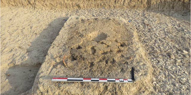 The small cup-shaped indents in this structure may have served a ceremonial purpose, according to archaeologists. (D. Sarmiento Castillo / Mission archéologique française du Peramagron)