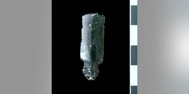 An arrowhead fragment made of obsidian, or volcanic glass. that was discovered at the site. The obsidian comes from Anatolia, which is several hundred miles from Kunara, according to experts.