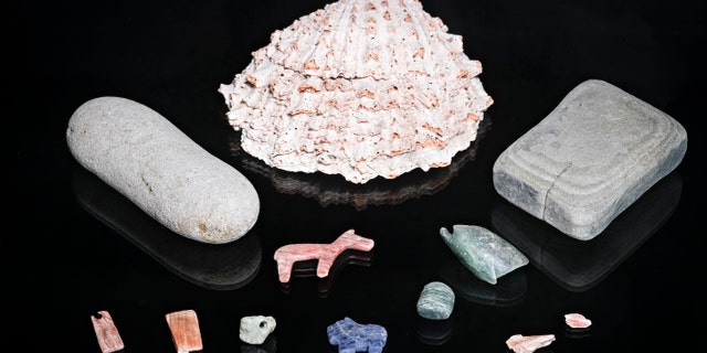 The researchers discovered semi-precious stone artifacts, including a lapis-lazuli puma figurine, at the bottom of the lake.