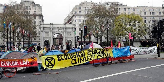 The road is blocked by protesters during a climate protest at Marble Arch in London, Tuesday, April 16, 2019. The Extinction Rebellion Group calls for a week of civil disobedience to what stands, the lack of addressing the causes of climate change.