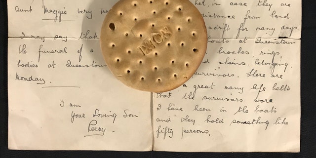The hardtack ship's biscuit and the letter describing its discovery. (Henry Aldridge and Son)