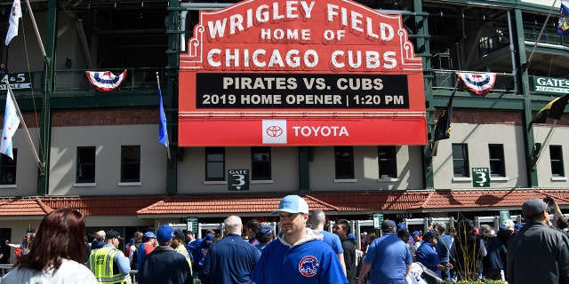 Fans walk around the ballpark before the Chicago Cubs home opening baseball game against the Pittsburgh Pirates, Monday, April 8, 2019, in Chicago.