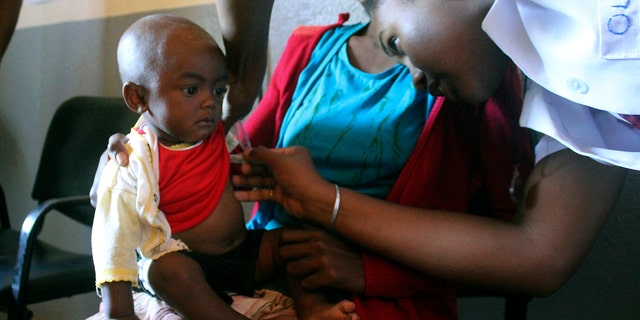 A volunteer nurse examines Sarobidy, a 6-month-old girl with measles, while her mother, Nifaliana Razaijafisoa, observes a health care center in Larintsena, Madagascar, on March 21, 2019. The island nation is confronted with largest measles outbreak in history and cases go well beyond 115,000. (Photo AP / Laetitia Bezain)