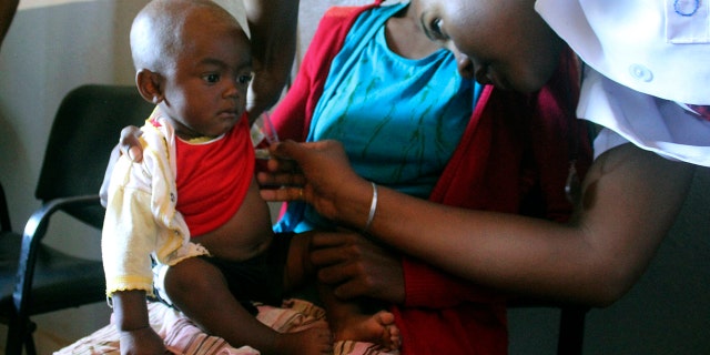 A volunteer nurse examines 6-moth-old Sarobidy, who is infected with measles, while her mother Nifaliana Razaijafisoa looks on, at a health care center in Larintsena, Madagascar, on March 21, 2019. The island nation faces its largest measles outbreak in history and cases soar well beyond 115,000. (AP Photo/Laetitia Bezain)