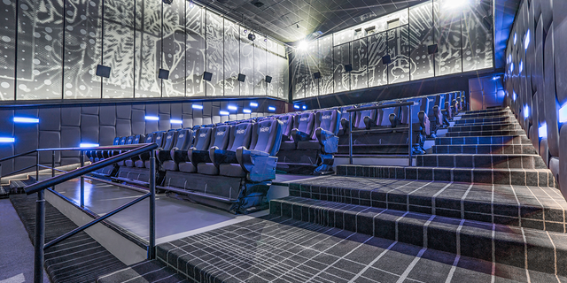 Pictured is a theater equipped with MX4D full motion cinema chairs that spray water, drop snow from the ceiling and whip the viewer around as if they were in the film.