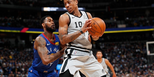 Denver Nuggets guard Will Barton, left, defends against San Antonio Spurs guard DeMar DeRozan during the first half of Game 1 of an NBA first-round basketball playoff series Saturday, April 13, 2019, in Denver. (AP Photo/David Zalubowski)