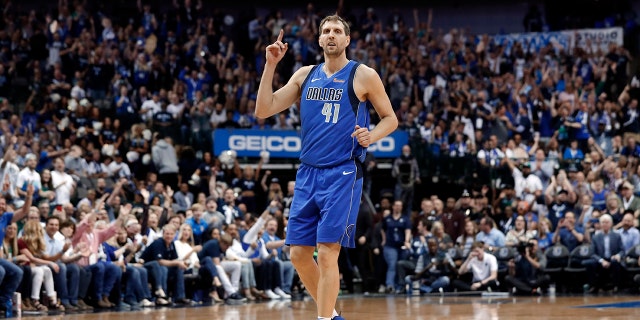 Dallas Mavericks' Dirk Nowitzki (41) celebrates sinking a 3-point basket during the second half of the team's NBA basketball game against the Phoenix Suns in Dallas, Tuesday, April 9, 2019. (AP Photo/Tony Gutierrez)