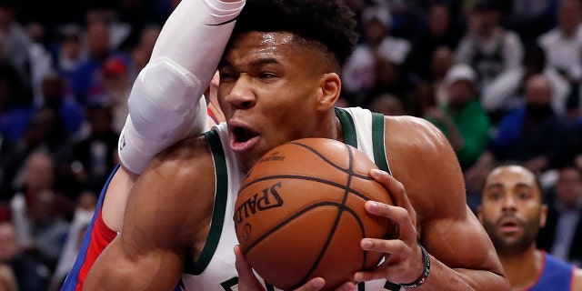 Milwaukee Bucks forward Giannis Antetokounmpo (34) is defended by Detroit Pistons forward Blake Griffin during the first half of Game 3 of a first-round NBA basketball playoff series, Saturday, April 20, 2019, in Detroit. (AP Photo/Carlos Osorio)