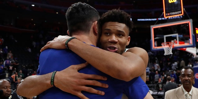 Milwaukee Bucks forward Giannis Antetokounmpo, front right, hugs Detroit Pistons center Zaza Pachulia after Game 4 of a first-round NBA basketball playoff series, Monday, April 22, 2019, in Detroit. (AP Photo/Carlos Osorio)