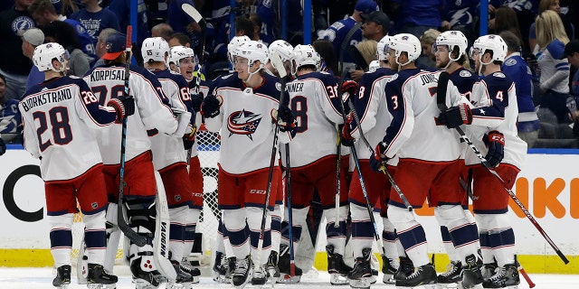 The Columbus Blue Jackets celebrates their 4-3 win over the Tampa Bay Lightning during Game 1 of an NHL Eastern Conference first-round hockey playoff series Wednesday, April 10, 2019, in Tampa, Fla. (AP Photo/Chris O'Meara)