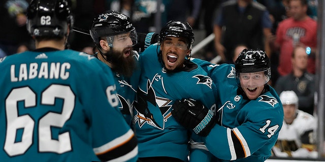 From left, San Jose Sharks' Kevin Labanc (62), Brent Burns, Evander Kane, and Gustav Nyquist (14) celebrate a goal by Joe Pavelski, not seen, against the Vegas Golden Knights during the first period of Game 1 of an NHL hockey first-round playoff series Wednesday, April 10, 2019, in San Jose, Calif. (AP Photo/Ben Margot)