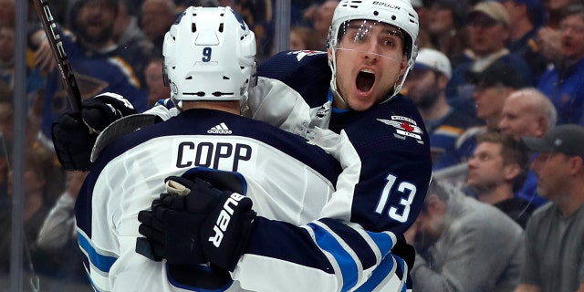 Winnipeg Jets' Brandon Tanev (13) is congratulated by teammate Andrew Copp after scoring during the third period in Game 3 of an NHL first-round hockey playoff series against the St. Louis Blues, Sunday, April 14, 2019, in St. Louis. The Jets won 6-3. (AP Photo/Jeff Roberson)