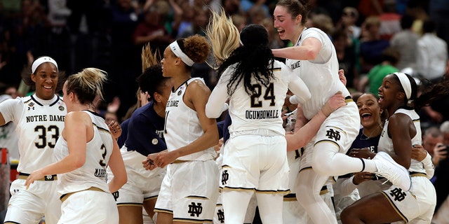 The Notre Dame team celebrates at the end of the team's 81-76 win over Connecticut during a Final Four semifinal of the NCAA women’s college basketball tournament Friday, April 5, 2019, in Tampa, Fla.(Associated Press)